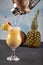 Pina Colada over wooden background garnished pineapple. A cocktail