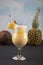 Pina Colada over wooden background garnished pineapple. A cocktail