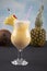 Pina Colada over wooden background garnished pineapple. A cocktail