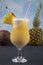 Pina Colada over wooden background garnished pineapple. A cocktail