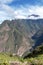 Pinchinuyok ancient Inca ruins surrounded by mountain peaks and clouds above the green canyon in Peru