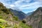 Pinchinuyok ancient Inca ruins surrounded by mountain peaks and clouds above the green canyon in Peru