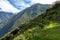 Pinchinuyok ancient Inca ruins surrounded by mountain peaks and clouds above the green canyon in Peru