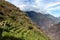 Pinchinuyok ancient Inca ruins surrounded by mountain peaks and clouds above the green canyon in Peru