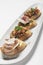 Pinchos tapas with jamon serrano and bruschetta on white background