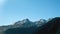 Pindos mountain range Greece. Snowy peak of Pindus misty mountain, forest blue sky background, space