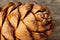 Pine cone peel texture with drops of resin on a gray wooden background. Cedar cone close-up