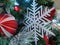 Pine cones, snowflakes, peppermints, and other ornaments decorating a Christmas tree for the holiday