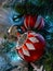 Pine cones, snowflakes, peppermints, and other ornaments decorating a Christmas tree for the holiday