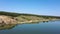 Pine forest on the lake. Trees are reflected in the water.