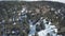 Pine forest on peak of mountain in daytime, snow is lying on ground, aerial view