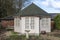 A pine garden office situated in the corner of a country garden