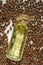 Pine nuts oil.shelled pine nuts and a bottle of cedar oil.glass bottle with yellow oil lies in pine nuts on a white