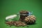 Pine nuts and pine cones in the glass jar  on a green background