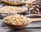 Pine nuts in the spoons on the wooden table. Macro. Organic food