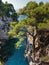 Pine trees on a rock over crystal clear turquoise water near Cape Amarandos at Skopelos island