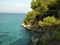 Pine trees on rocky Aegean coast, Agistri, Greece