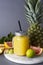 Pineapple cocktail or juice in glass jar bottle with straws and fruits on background - pineapple, oranges, grapefruit, lime and
