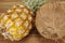 Pineapple and coconut on an acacia tabletop - close shot