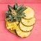 pineapple on dish slice on pink wood