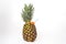 Pineapple, fruit on a white background, with a straw in the spout to be able to drink like a juice bottle, close-up