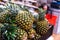 Pineapple fruits in a cardboard box. Wholesale and retail trade in exotic fruits. Close-up