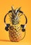 Pineapple with headphones and glasses