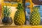 Pineapple, that are placed in wooden crates, fresh taste sweet.