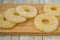 Pineapple rings on a wooden board. Canned ananas slices