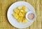 Pineapple slice dipping with mixed sugar salt and pepper on white plate