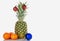 Pineapple, tangerines, Christmas toy on a white background