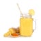Pineapple, turmeric, ginger smoothie in a mason jar with ingredients isolated on a white background.