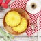 Pineapple on a wooden plate decorated with Christmas with cup of coffee, measuring tape and dumbbells