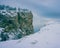 Pines and rocks evening snowy winter landscape