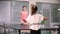 Ping pong playing. Young woman playing table tennis with her friend. Back view