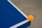 Pingpong ball hits the corner of blue pingpong table