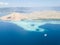 Pinisi Ship, Coral Reef, and Island in Indonesia