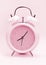 Pink alarm clock, close up.