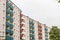 Pink apartment buildings with red, white and green balconys