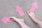 Pink Arrow Choice Concept. Female Bare Feet with Pink Nail Polish Manicure Standing and Many Direction Arrows Choices on the Road