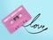 Pink audio cassette tape with label tag love song tangled tape