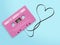 Pink audio cassette tape with label tag love song tangled tape