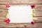 Pink azalea flowers with white asystasia gangetica flowers and empty paper sheet on a wooden background, top view, space for text