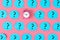On the pink background is a alarm clock. Around him are glued many blue stickers with question marks. Concept, a matter