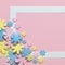 Pink background with colorful flowers and frame for text.