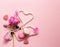 Pink background with flowers and macaroons, sweet