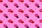 Pink background with paper lips in form of kiss and sweet cherry