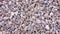 Pink background from sea pebbles or tumbling red marble chips. Natural stone chips for landscape design of garden paths and