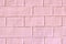 Pink background with structural brickwork