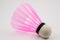 Pink badminton shuttlecock on a white